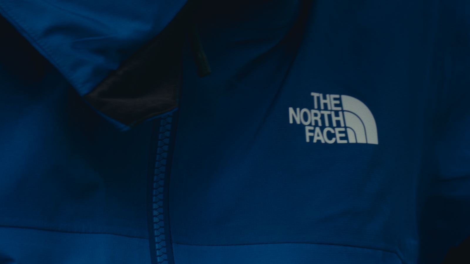 Close up of a blue jacket with The North Face logo
